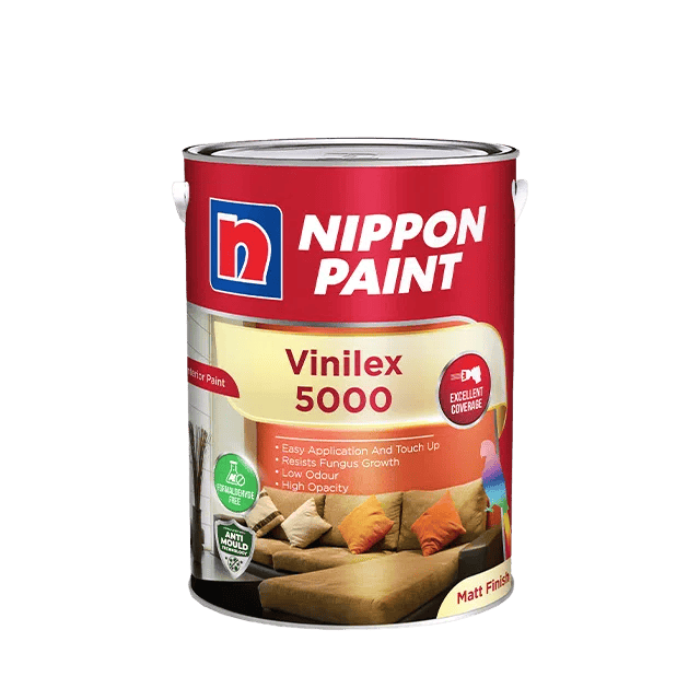 Nippon paint vinlex 5000 interior wall paint can with sofa and cushions in background.
