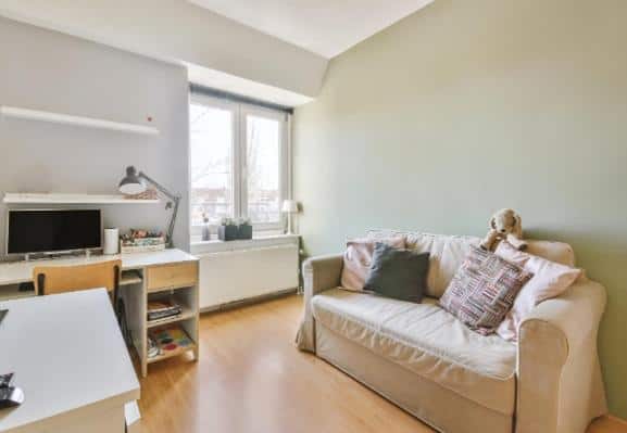 Resale HDB living room with freshly painted walls and cozy furniture in Singapore.