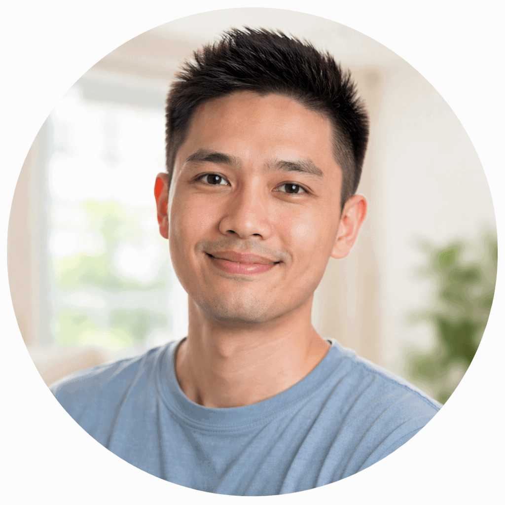 A smiling man in casual clothing indoors, representing professional painting services in singapore.